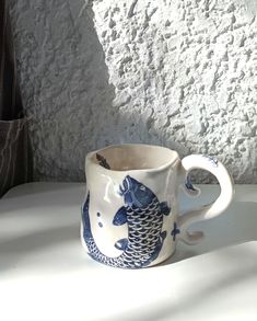 a blue and white mug sitting on top of a table