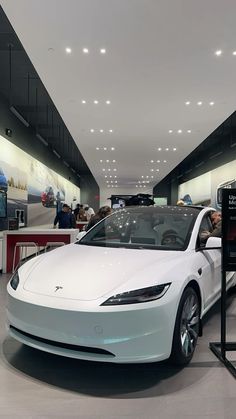 an electric car is on display in a showroom