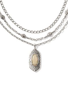 You’ll have all your bases covered (and fits accessorized) with the Keziah Vintage Silver Strand Necklace in Natural Mother-of-Pearl. A stone pendant in our signature shape steals the spotlight with an intricately etched frame, while two vintage-inspired metal chains add depth and texture to this multi strand stunner. This three-in-one style is also adjustable, so you can change the length of your pre-layered look to your liking. This necklace is a part of Yellow Rose by Kendra Scott—a brand tha Stackable Silver Necklace, Dainty Silver Necklace Stack, Silver Vintage Jewelry, Simple Silver Jewelry, Silver Strand, Thick Chain Necklace, Ethereal Aesthetic, Chunky Necklaces, Silver Statement Earrings