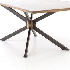 a wooden table with metal legs on a white background