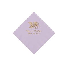 a purple napkin with a gold foil flower on the front, and a date printed on it