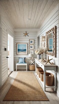 a hallway with white walls and wooden floors, decorated in blue and white decor on the wall