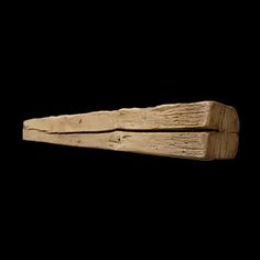 a piece of wood that has been carved into the shape of a long, rectangular object