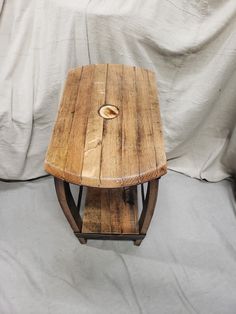 a wooden table sitting on top of a white sheet