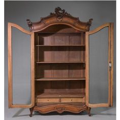 an antique wooden bookcase with glass doors