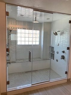 a walk in shower sitting inside of a bathroom