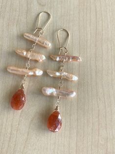 Sunstone and Peach Biwa Pearl Gold-filled Earrings - Etsy Orange Earrings For Everyday Summer Wear, Handmade Coral Earrings For Summer, Handmade Dangle Pearl Earrings For Summer, Peach Earrings For Summer Gift, Handmade Peach Dangle Earrings, Handmade Apricot Earrings In Elegant Style, Handmade Apricot Earrings Elegant Style, Handmade Elegant Apricot Earrings, Earring Inspiration