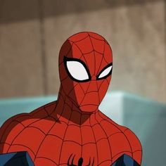 spider - man looking at the camera with his eyes wide open