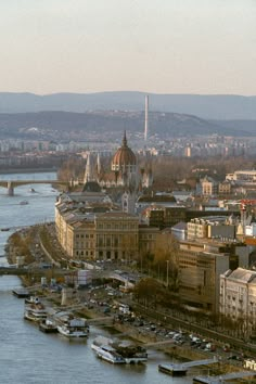 an aerial view of a city with boats in the water