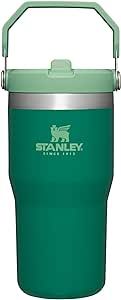 the stanley insulated cup is green and has a metal handle on one side, and an insulated lid on the other