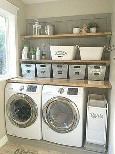 a washer and dryer in a laundry room with baskets on the shelves above them