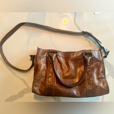 Used But Clean. Non-Smoking Home. Tag Still Inside. 9” Tall By 14” Long. Comes With Hook Inside For Keys And You Can Detach Crossbody Strap If You Want. Brown Leather Bag With Signature Hardware, Brown Satchel With Signature Hardware For Everyday, Classic Brown Shoulder Bag With Signature Hardware, Leather Satchel With Signature Hardware For Daily Use, Crossbody Strap, Satchel, Bag Lady, Buy And Sell, Handbags