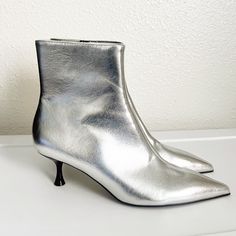 Zara Silver Metallic Ankle Boots Size: 6.5 Details New With Tags Side Zip Closure Approx 2" Heel Smoke Free Home. Chic Silver Heels For Fall, Sleek Low Heel Party Boots, Chic Silver Boots With Metal Feet, Silver Ankle-high Heels For Spring, Chic Silver Heels Medium Width, Silver Fitted Ankle-high Heels, Glamorous Metallic Silver Boots With Pointed Toe, Chic Silver Heels For Winter, Glamorous Metallic Silver Pointed Toe Boots