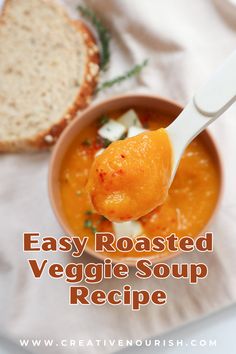 an easy roasted veggie soup recipe in a bowl with a spoon and bread on the side