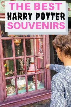 a young boy looking through a window at a harry potter display