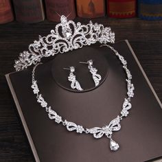 a tiara and earring set on top of a book