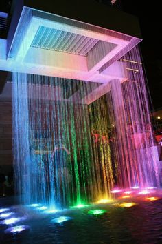 an image of a water fountain with rainbow lights