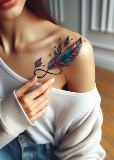 a woman with a feather tattoo on her shoulder