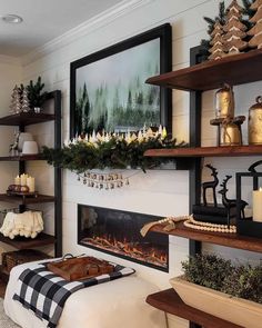 a living room decorated for christmas with candles and decorations on the fireplace mantels