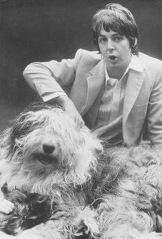 the man is posing with his dog in this black and white photo