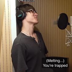 a woman wearing headphones standing in front of a microphone with the words melting you're trapped