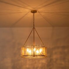 a chandelier hanging from the ceiling in a room with clouds and blue sky