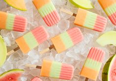 watermelon and apple popsicles on ice cubes with slices of melon