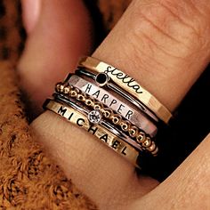 GORGEOUS stacking name rings set, including three personalized name rings and spacer rings. This mixed metal set is a great gift for mom or grandma! THIS STACKABLE NAME RING SET INCLUDES ALL OF THE RINGS IN THE FIRST PHOTO -a 2 mm name ring in lowercase cursive -a 1mm black cz ring -a 2mm name ring in uppercase thin font -a beaded spacer ring -a 1 mm clear cz ring -a 2mm name ring in uppercase bold block font These are separate rings and can be put in any order Six total rings... We recommend si Personalized Stackable Rings, Stackable Name Rings, Stacked Rings, Grandmother Jewelry, Rings Stacking, Necklace Combo, Ring Cuts, Ring Spacer, Name Ring