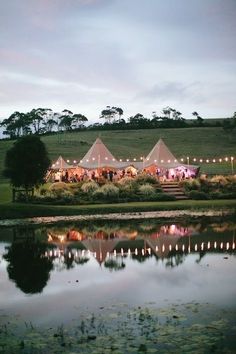 a group of tents sitting next to a body of water