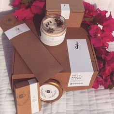 an open box with some items on top of it and flowers in the back ground