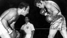 two men standing next to each other with boxing gloves on