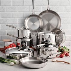 an assortment of pots and pans on a table