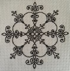 a black and white embroidered design on a piece of cloth