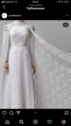 a woman in a white gown and cape