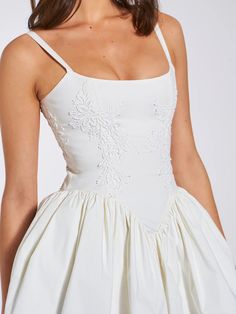 Introducing the alluring Kadi White Cotton Corset Mini Dress, a delightful addition to your wardrobe. Crafted from crisp low stretch Cotton Poplin, this mini dress exudes casual elegance. Delicate lace detailing adorns the garment, adding a touch of charm. The V-shaped waistline and the built-in bones accentuates your Drop Waist Short Wedding Dress, Wedding Dress Cotton, V Shaped Waistline Dress, Corset White Dress, Wedding Corset Dress, Mini Bridal Dress, White Grad Dress, Embroidered White Dress, White Corset Dress