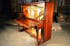 a wooden desk with a mirror on it in a room filled with wood planks