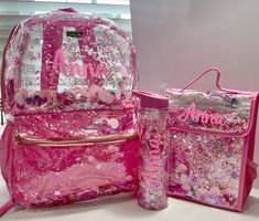 Personalized Clear Backpack with matching Lunchbox and water bottle. Processing time is typically 3-7 business days before shipping. The color on the items in the main photo is florescent pink. Please note, the backpack and lunchbox are personalized with permanent glitter adhesive vinyl. The lunchbox is not clear, only the backpack. You can do a name, initials or single initial on the items. If you want initials please leave them in the order you want it to appear, traditional monogram is first, LAST, middle. Backpack Specs - Dimensions: 12W x 5" D x 16" H - Clear vinyl backpack with trapped confetti with front pocket - 2 exterior mesh pockets for a water bottle - Purple nylon adjustable straps & top handle  CARE: Spot clean with a damp white cloth Lunchbox Specs Gold insulated interior Ve Traditional Monogram, Glitter Backpack, The Lunchbox, Clear Backpack, Name Initials, Pink Party, Pink Parties, Clear Vinyl, Pink Glitter