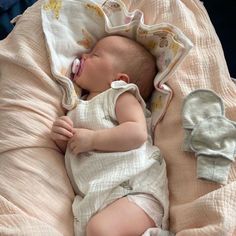 a baby laying on top of a pink blanket