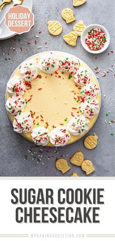 a cake with white frosting and sprinkles on it, surrounded by cookies