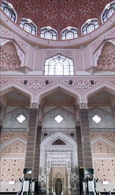 the inside of a large building with many windows and arches on it's sides