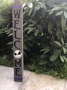 a wooden sign that says welcome to me with a skull on the front and side