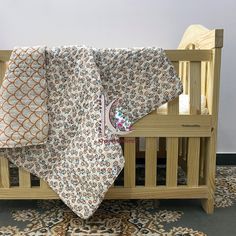 a baby crib with a blanket on top of it