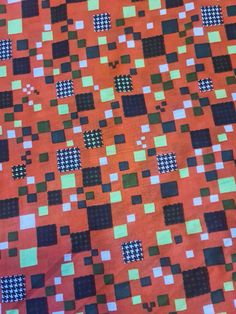 an orange and black quilt with squares on it