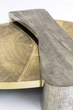 a close up of a wooden bench with an interesting design