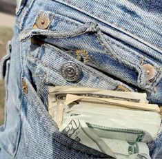 money sticking out of the back pocket of someone's jeans