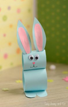 a blue paper bag with a bunny face on it's side, sitting on a table