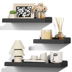 two black shelves with candles, vases and other decorative items on top of them