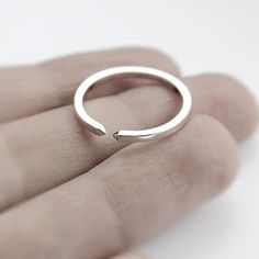 Handmade polished sterling silver ring. It's a simple band with a gap at the top flanked with two tiny pyramids. It can be a nice wedding band.Band Width: 1.5mmCan't find your size? Contact us for a custom order.A thicker oxidized version is available here: https://www.etsy.com/listing/195927320/two-close-double-pyramid-oxidized* Due to the open band design, size can be slightly adjusted.Visit my shop for the complete collection: http://www.etsy.com/shop/jewelryMirta© MIRTA Silver Open Ring Stackable Rings In Minimalist Style, Modern Sterling Silver Couple Open Rings, Minimalist Open Band Midi Ring For Promise, Minimalist White Gold Initial Ring, Minimalist Stackable Open Couple Rings, Minimalist Silver Initial Ring, Minimalist White Gold Open Midi Rings, Minimalist Silver Initial Open Ring, Simple Silver Open Ring