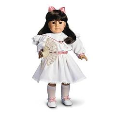 the doll is wearing a white dress with pink bows on her head and holding a fan