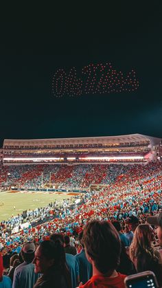 a stadium filled with lots of people watching fireworks